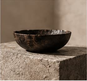 Handcrafted object displayed on a stone pedestal